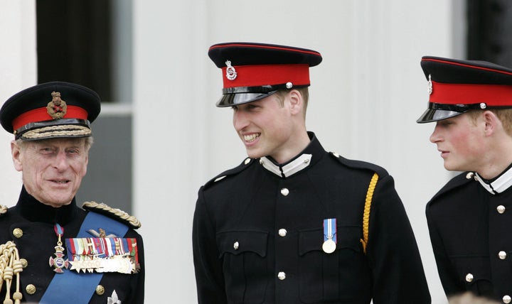 Prince Philip talks with his grandsons Prince William and Prince Harry at the Sovereign's Parade at Sandhurst Military Academ