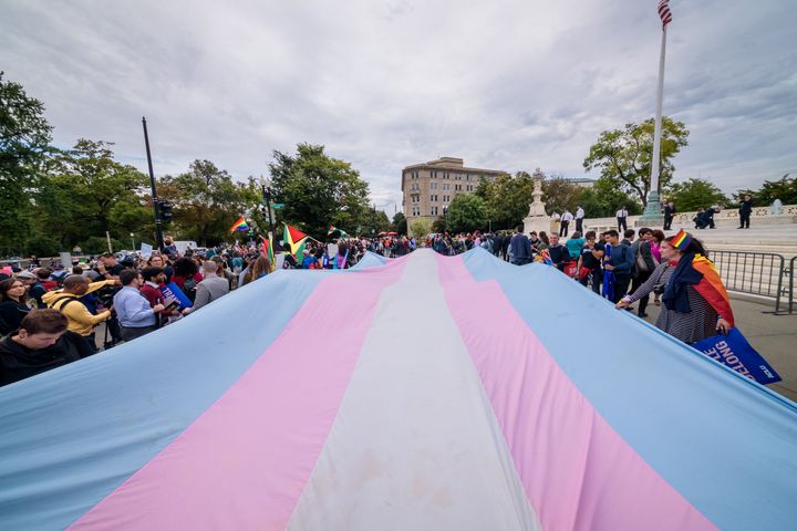Demonstrators unfurl a giant Trans Pride flag outside the U.S. Supreme Court in 2019.