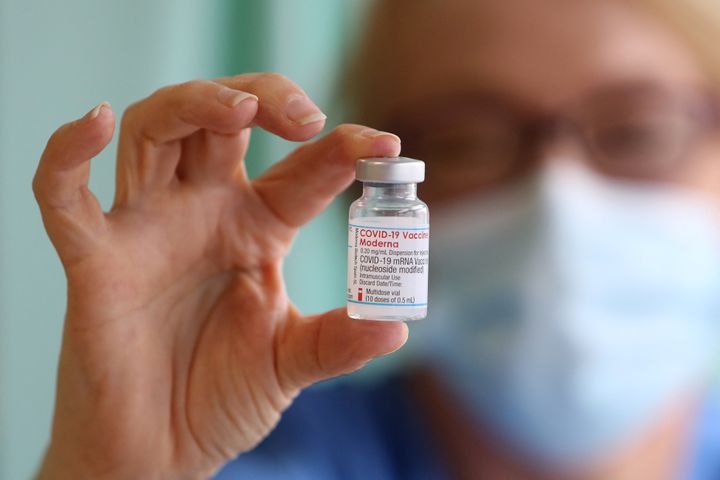 Nurse Lisa Kieh holds a vial of the Moderna Covid-19 vaccine at a vaccination centre in Llanelli, South Wales