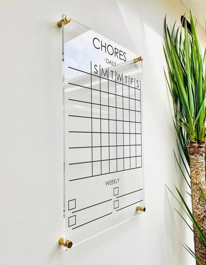 An acrylic wall-mounted chore chart