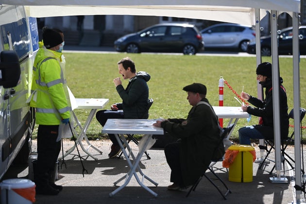 <strong>People take Covid-19 tests at a mobile coronavirus surge testing centre in south London.</strong>