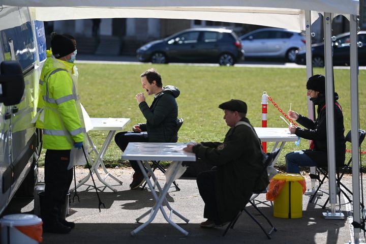 People take Covid-19 tests at a mobile coronavirus surge testing centre in south London.