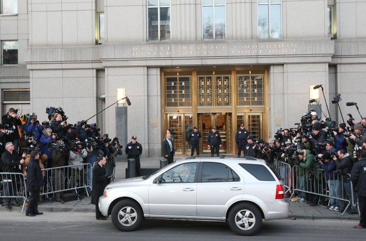 Madoff's vehicle is seen surrounded by members of the press as he arrives at the Manhattan Federal court on March 12, 20