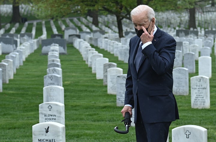 President Joe Biden wipes his eye as he walks through Arlington National Cemetery in Virginia on Wednesday.&nbsp;