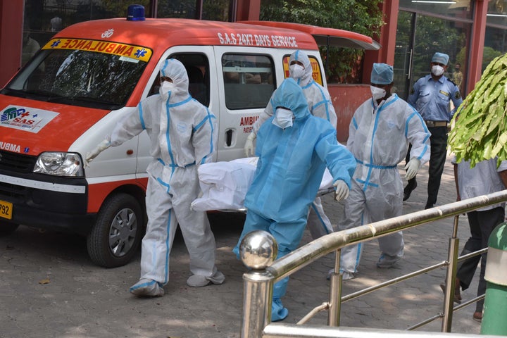 The last rites are performed for a person who died of COVID-19 on Wednesday in New Delhi, India. 