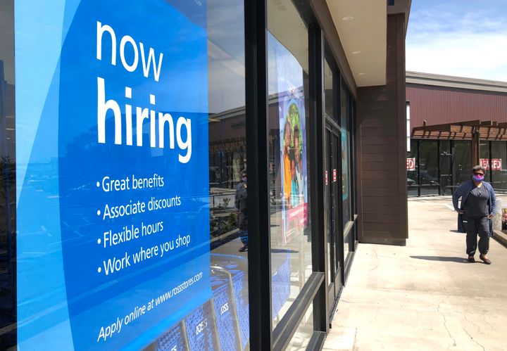 A pedestrian walks by a now hiring sign at Ross Dress For Less store on April 02, 2021, in San Rafael, California. The Labor Department said Thursday that unemployment applications plummeted by 193,000 from a revised 769,000 a week earlier.