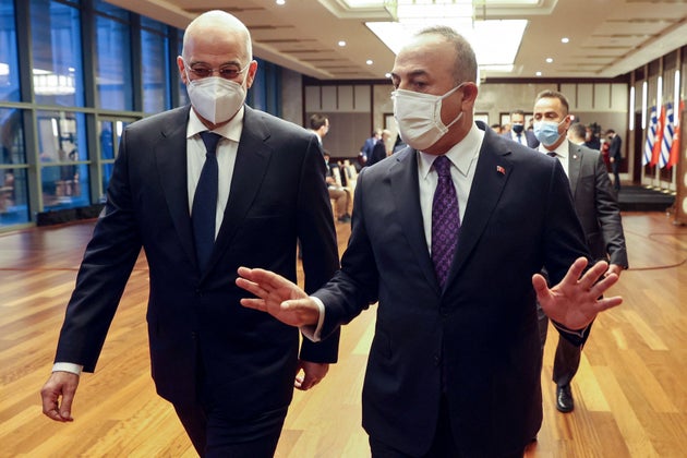 Turkish Foreign Minister Mevlut Cavusoglu (R) speaks with Greek Foreign Minister Nikos Dendias as they arrive to the press conference following their meeting in Ankara on April 15, 2021. (Photo by Adem ALTAN / AFP) (Photo by ADEM ALTAN/AFP via Getty Images)