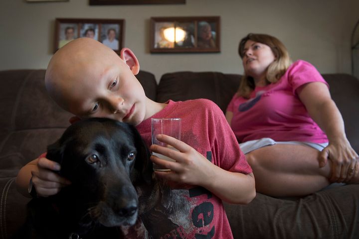 Trevor Beckermann and his mother, Meagan Beckermann, pictured in 2017 at their home near the West Lake Landfill, a Superfund site, in greater St. Louis, Missouri. The family blames the child's autoimmune disease on exposure to toxic contaminants at the site. 