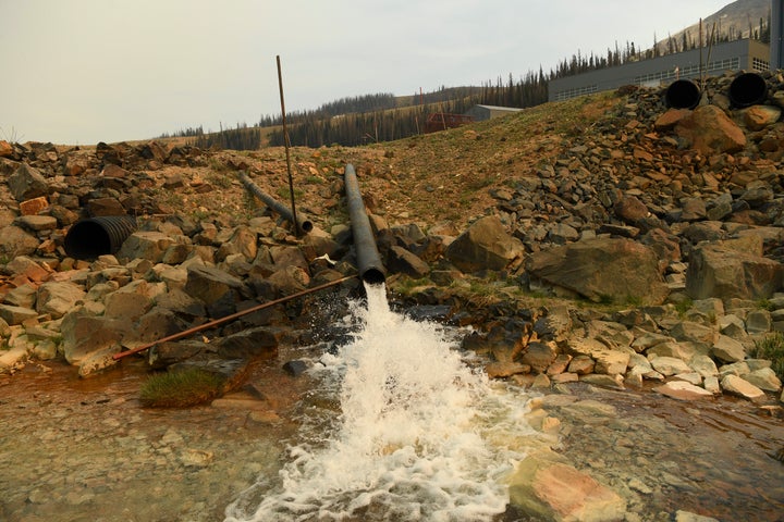 A pipe flows from a state water treatment plant at the Superfund site at Summitville Mine in Summitville, Colorado. 