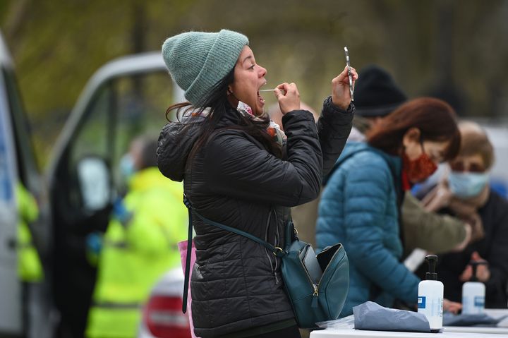 People take part in coronavirus surge testing on Clapham Common, south London.