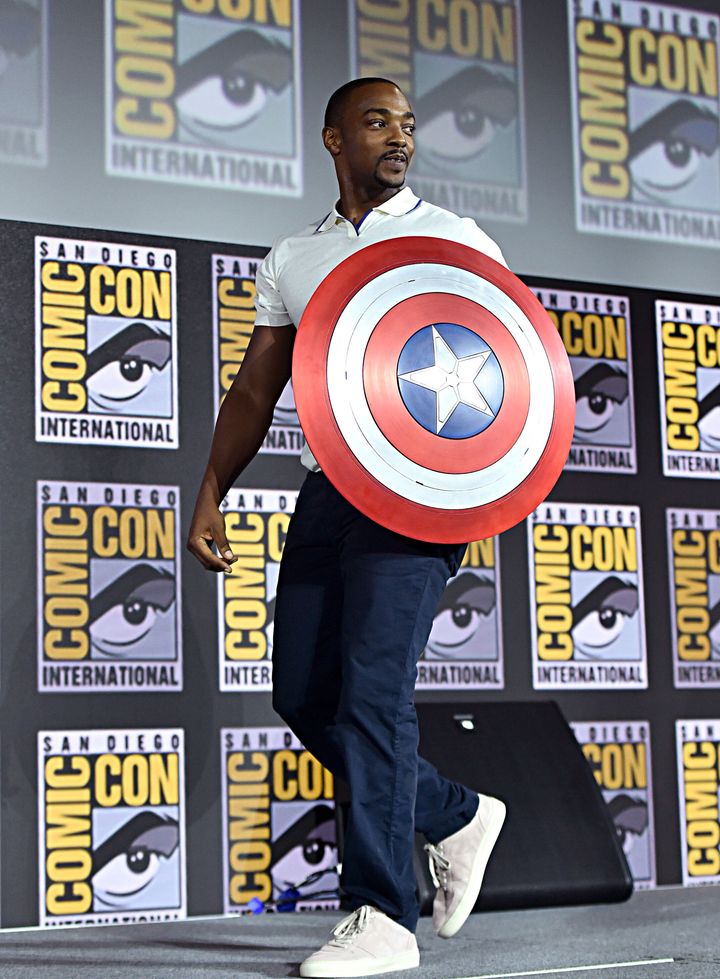 Anthony Mackie, who plays Falcon, carries Captain America's shield at the San Diego Comic-Con International 2019 Marvel Studios Panel.