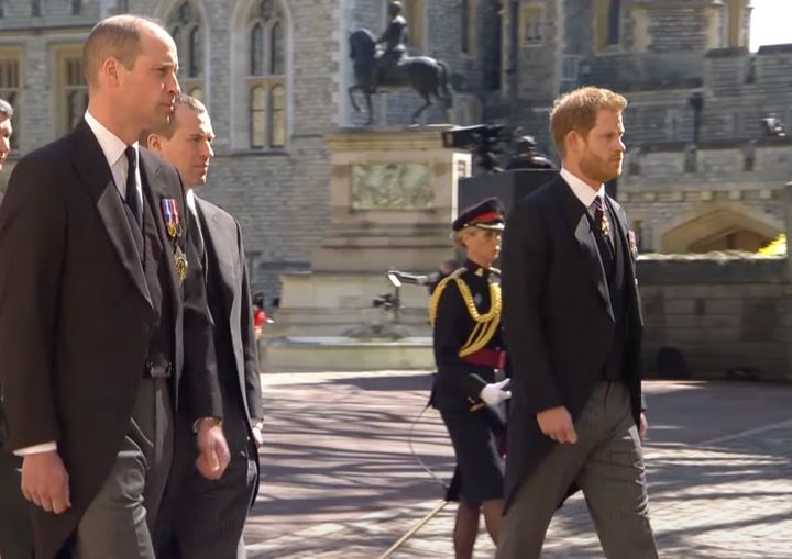Prince William, left, walks in the funeral procession near Prince Harry, right.