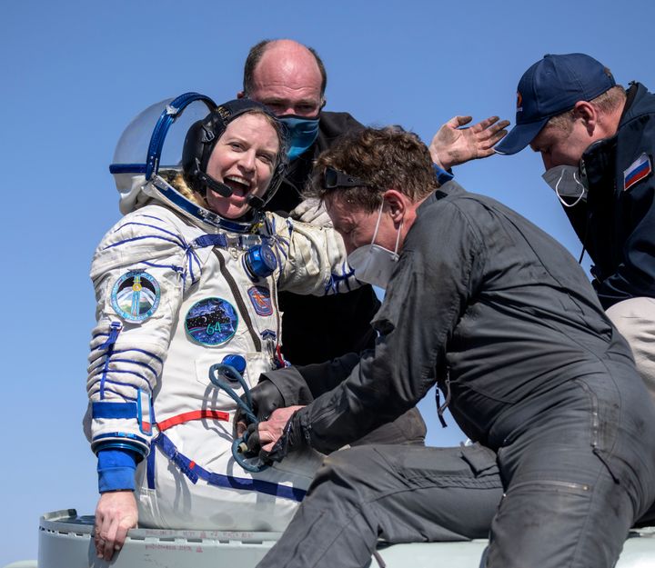 Expedition 64 NASA astronaut Kate Rubins is helped out of the Soyuz MS-17 spacecraft.