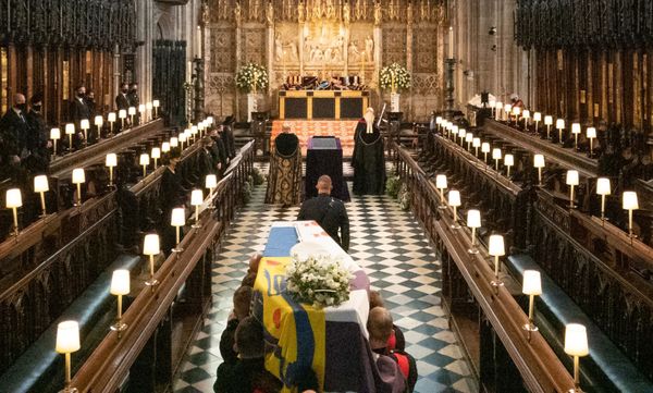 The coffin is carried into the quire during the funeral service.