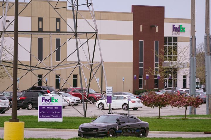 A sheriff's car blocks the entrance to the FedEx facility in Indianapolis, Saturday, April 17, 2021 where eight people were killed during a shooting late Thursday night.