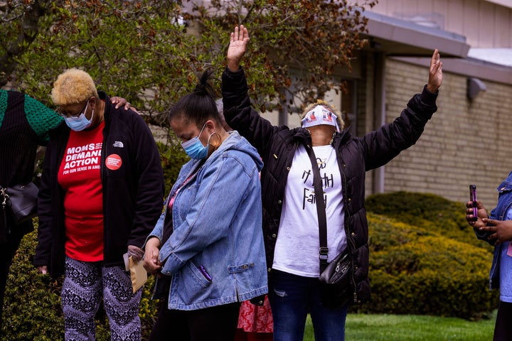Connie Nance raises her arms in prayer during a vigil at the Olivet Missionary Baptist Church in Indianapolis, Saturday, April 17, 2021 for the victims of the shooting at a FedEx facility.