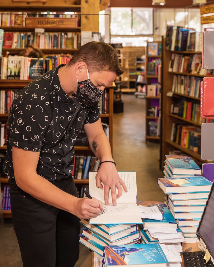 Couch signs copies of "The Sky Blues" at Skylight Books in Los Angeles. 