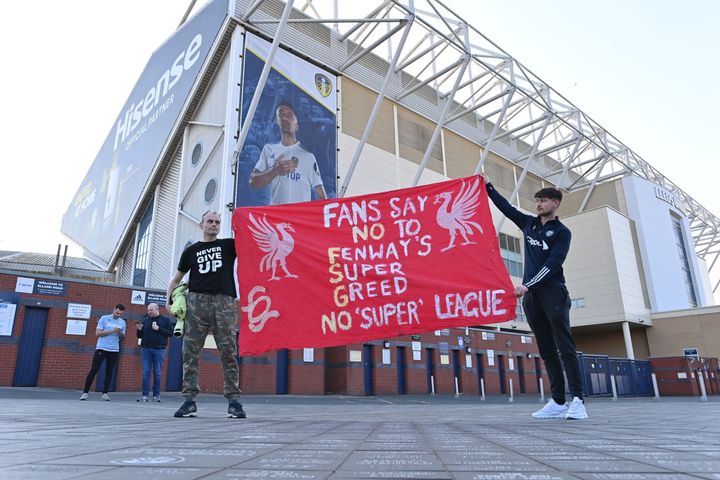 Fans hold a banner outside Elland Road.