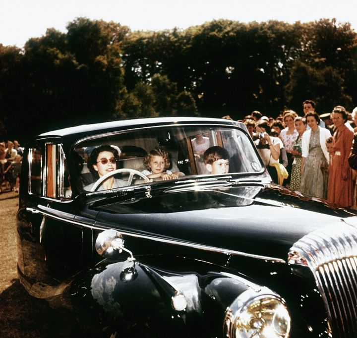 Queen Elizabeth driving Prince Charles and Princess Anne at Windsor in 1957.