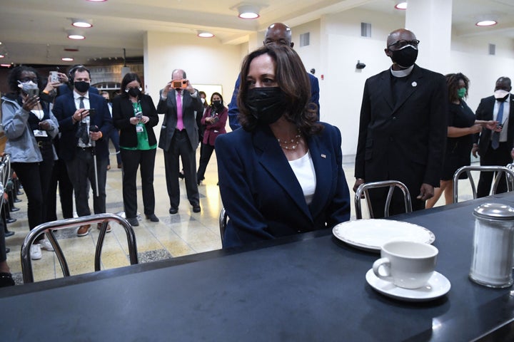 Harris sits at the lunch counter where four Black college students began a sit-in protest in 1960.