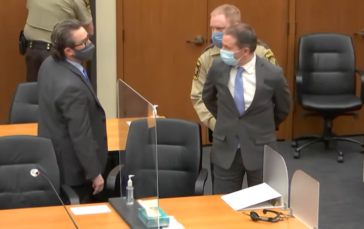 Defense attorney Eric Nelson (left) looks on as Derek Chauvin (right) is taken into custody Tuesday after the verdicts were read by the judge.