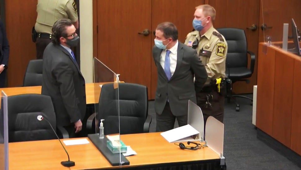 In this image from video, former Minneapolis police officer Derek Chauvin is taken into custody as his attorney, Eric Nelson,