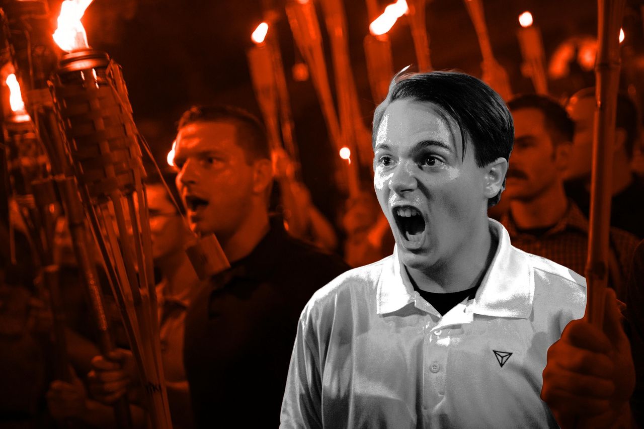 Peter Cytanovic and other white nationalists encircle counter-protesters at the base of a statue of Thomas Jefferson after marching through the University of Virginia campus with torches in Charlottesville, Virginia, on Aug. 11, 2017. 