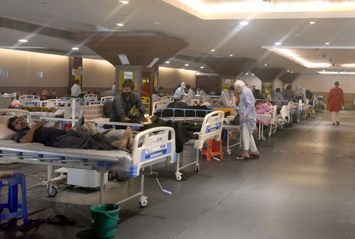 Coronavirus patients receive treatment at Shehnai Banquet Hall COVID-19 care centre attached to LNJP Hospital in New Delhi, India.