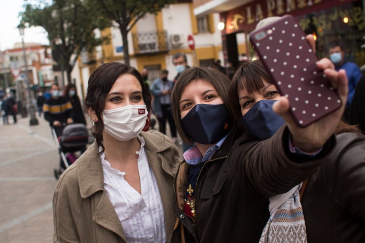 La presidenta de la Comunidad de Madrid y candidata a la reelección, Isabel Díaz Ayuso, se hace un selfie durante una visita a Fuenlabrada, bastión de los socialistas.