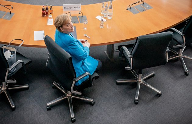 German Chancellor Angela Merkel is seated prior to testifying in front of a parliamentary committee investigating...