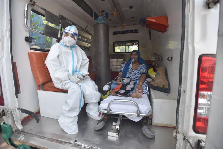 A COVID-19 patient seen inside an ambulance while waiting for admission amid shortage of beds, at LNJP Hospital on April 22,