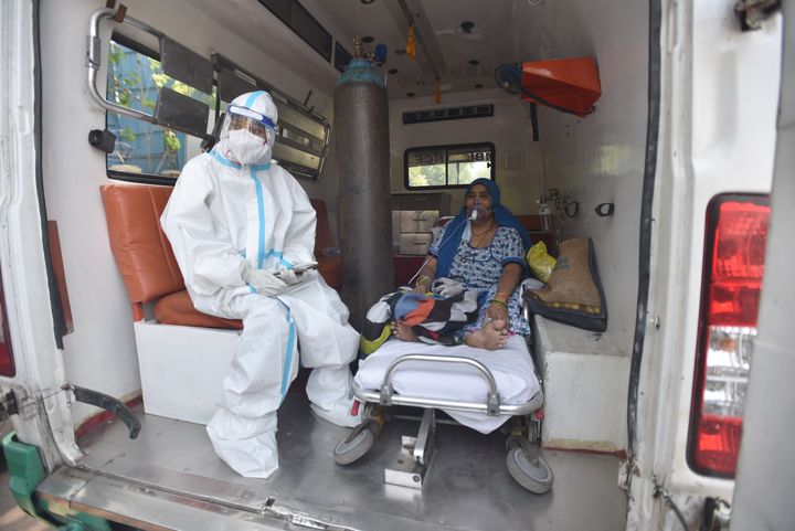 A COVID-19 patient seen inside an ambulance while waiting for admission amid shortage of beds, at LNJP Hospital on April 22, 
