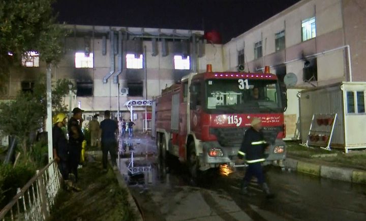 In this image made from video, first responders work the scene of a hospital fire in Baghdad on Saturday, April 24, 2021. The