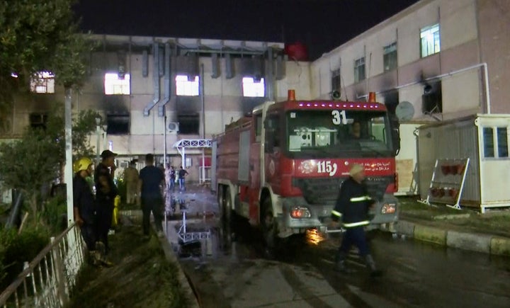 In this image made from video, first responders work the scene of a hospital fire in Baghdad on Saturday, April 24, 2021. The fire broke out in the Baghdad hospital that cares for coronavirus patients after oxygen cylinders reportedly exploded late Saturday, officials said. (AP Photo)