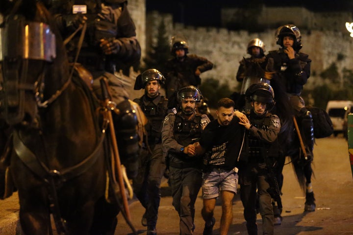 JERUSALEM - APRIL 23: Israeli forces intervene Palestinian Muslims, who gathered in Damascus Gate after performing Tarawih prayer in Al-Aqsa Compound, with water cannon vehicles and sound bombs to now allow for gathering at Old Town district in Eastern Jerusalem on April 23, 2021. 105 Palestinians injured during Israeli interventions. (Photo by Mostafa Alkharouf/Anadolu Agency via Getty Images)