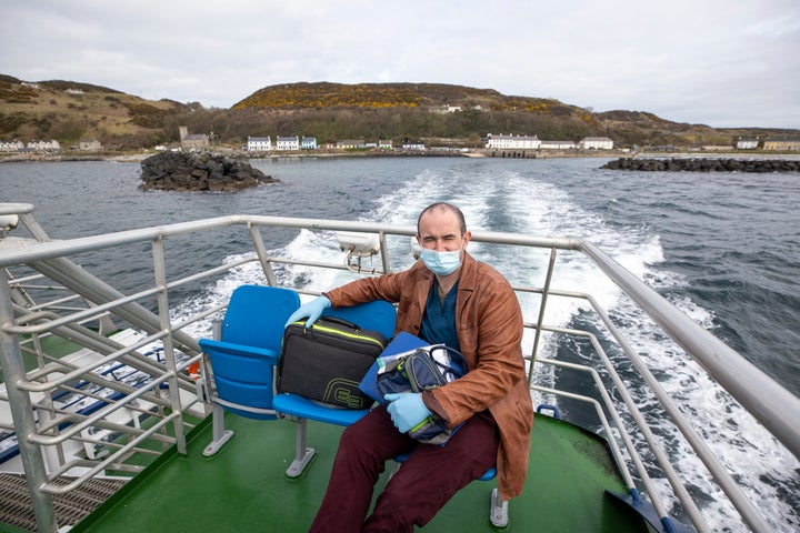 Dr Gavin Chestnutt travelling by boat to deliver a vaccine.