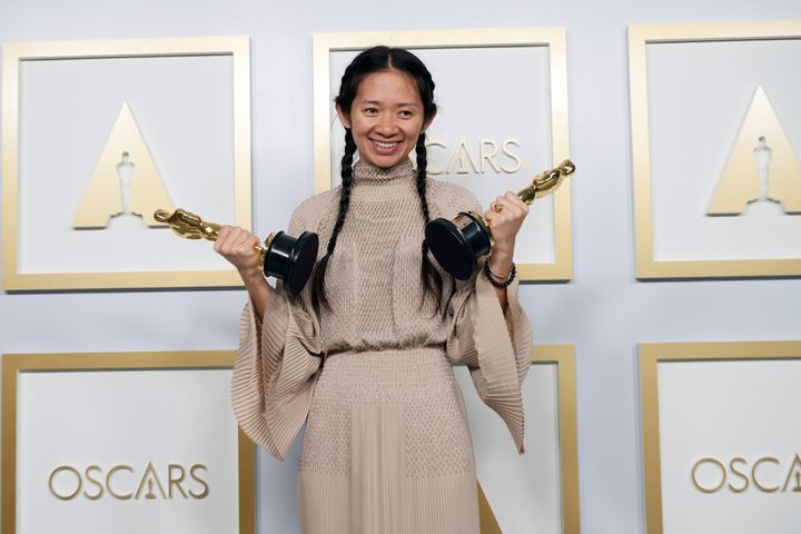 Chloé Zhao shows off both of her Oscars in the press room of the Academy Awards in Los Angeles.