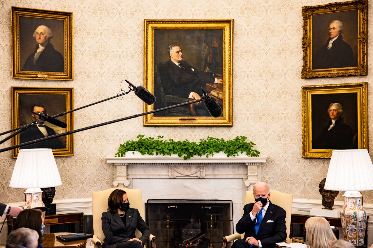 President Joe Biden sits beneath a painting of Franklin Roosevelt during a meeting with Vice President Kamala Harris and other lawmakers in the Oval Office. (Photo by Samuel Corum/Getty Images)
