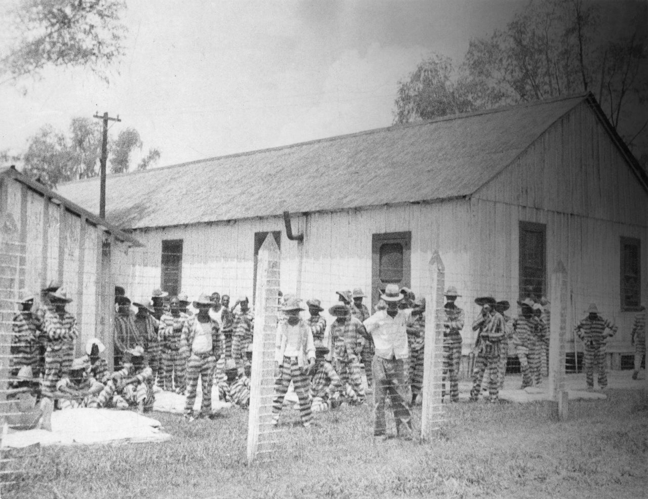 Bluesman Huddie Ledbetter, known as Leadbelly, standing in the foreground at prison compound No 1. in the Louisiana State Penitentiary. Alan Lomax first recorded Leadbelly as part of the New Deal's Federal Music Project. (Photo by Alan Lomax/Library of Congress/Corbis/VCG via Getty Images)