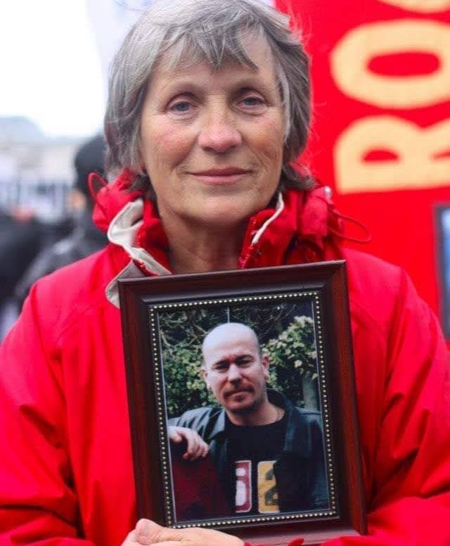 Lloyd's mother Jan Butler at a campaign rally holding a picture of her only son