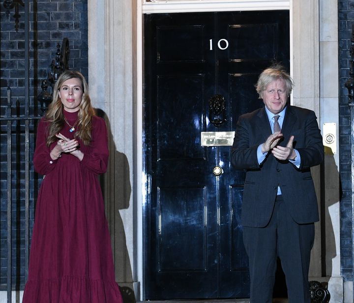 Boris Johnson and his partner Carrie Symonds stand outside 10 Downing Street