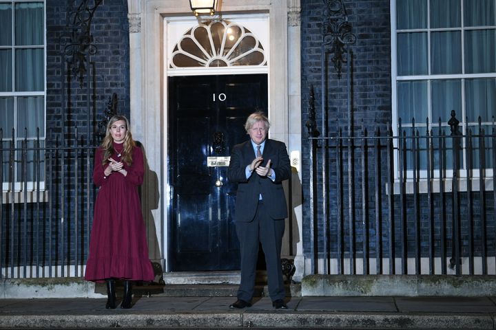 Boris Johnson and his partner Carrie Symonds stand outside 10 Downing Street