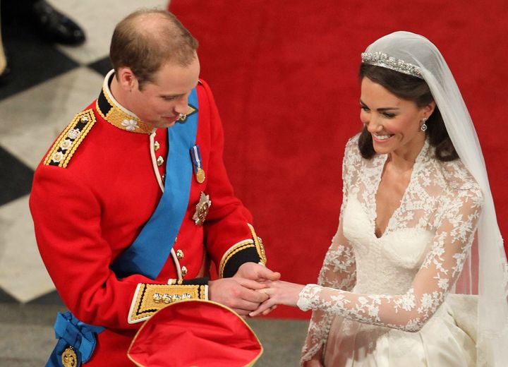 William places a wedding ring on the finger of his bride.