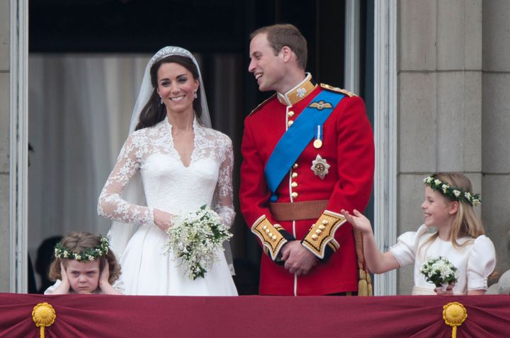 William and Kate on the balcony at Buckingham Palace. Grace van Cutsem (lower left) covers her ears as planes fly by.