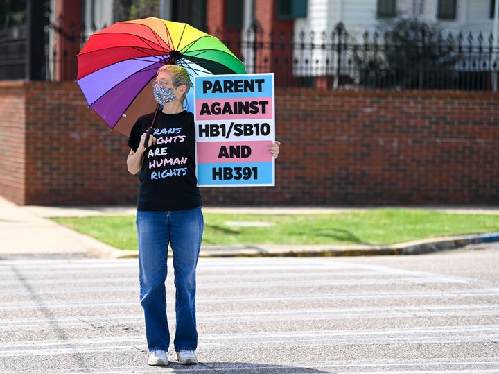 Jan Newton crosses the street in Montgomery to attend a rally held to draw attention to the anti-transgender legislation introduced in Alabama on March 30.