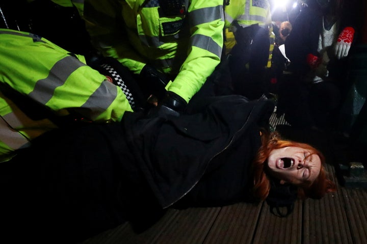 Police detain Patsy Stevenson as people gather at a memorial site in Clapham Common Bandstand following the murder of Sarah Everard.