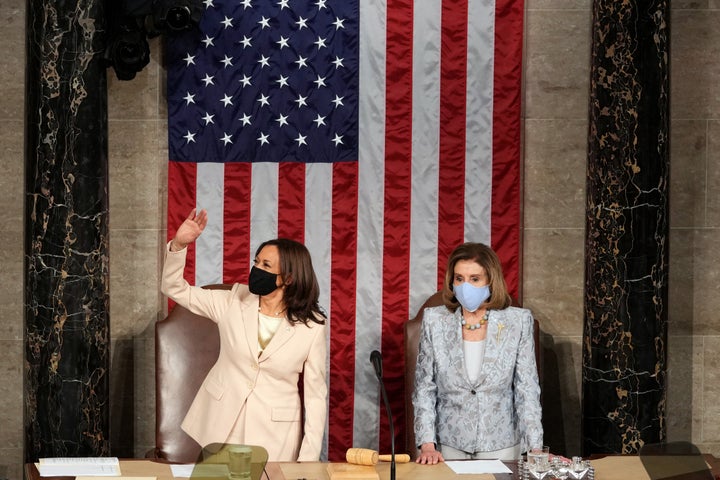 US Vice President Kamala Harris (L) waves as Speaker of the US House of Representatives Nancy Pelosi, Democrat of California,