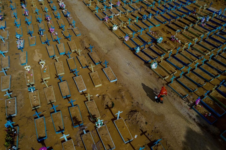 A gravedigger walks among COVID-19 victims' graves at the Nossa Senhora Aparecida cemetery in Manaus, Amazonas state, Brazil,