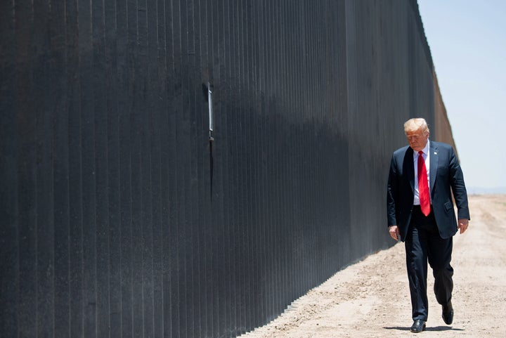 Then-President Donald Trump participates in a ceremony commemorating the completion of the 200th mile of border wall in June