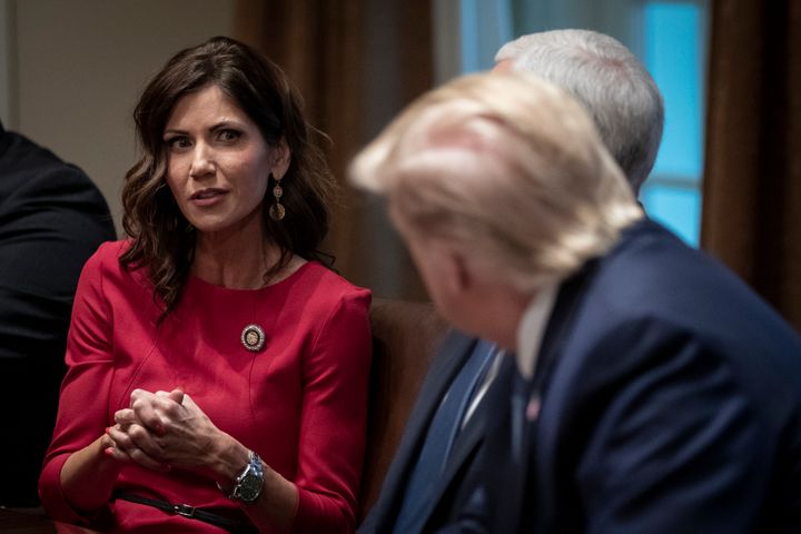 Kristi Noem, pictured talking to Donald Trump in 2019, believes the denial of the fireworks permit is politically motivated.